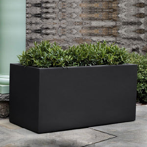 Sandal Planter 361818 - Onyx Black Lite - S/1 on concrete filled with plants