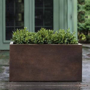 Sandal Planter 361818 - Rust Lite - S/1 on concrete filled with plants