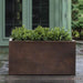 Sandal Planter 361818 - Rust Lite - S/1 on concrete filled with plants