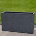 Sandal Planter 591836 - Charcoal Premium Lite - S/1 on concrete in the backyard