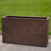 Sandal Planter 591836 - Rust Lite - S/1 on concrete in the backyard