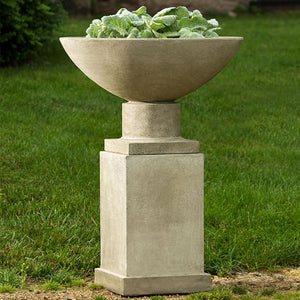Savoy Planter on pedestal filled with plants in the backyard