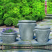 Scroll Handle Tub Planter on ledge against green plants