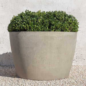 Design Urb Series 2 30" X 20" planter on gravel filled with plants