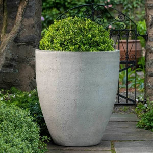 Design Urb Series 3 28 inch by 31 inch greystone planter on stone patio