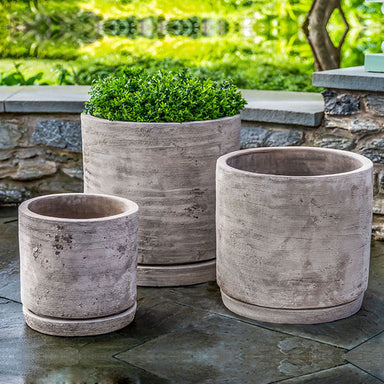 Sgraffito Planter Antico Terra Cotta S/3 filled with plants in the backyad