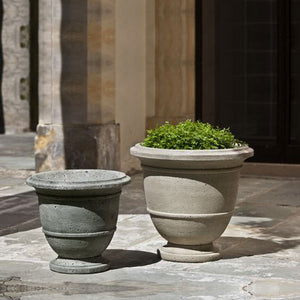 Small Relais Urn Planter filled with plants in the backyard