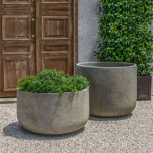 Tribeca Planter, Extra Large on gravel beside a planter that filled with plants