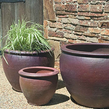 Tron Cao Pot Planter - Black Clay S/3 on gravel filled with plants