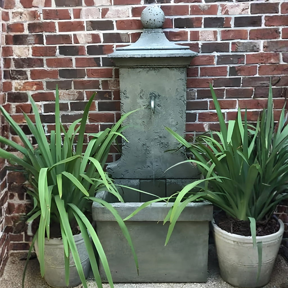 vence wall fountain against red brick wal